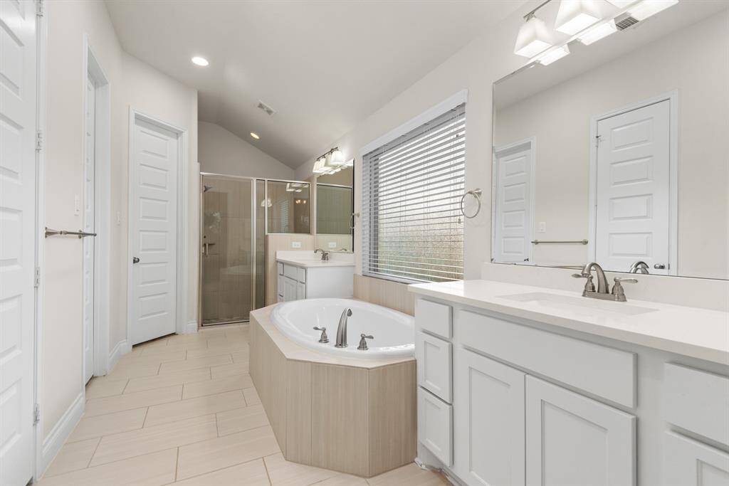 Spa-like primary bedroom ensuite with double sinks, soaking tub, separate shower and 2 walk in closets.