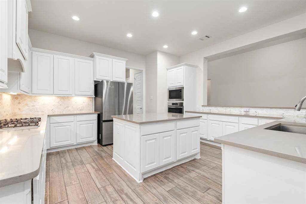 This kitchen is magazine worthy. Great island, tons of storage, under cabinet lighting and fridge stays.