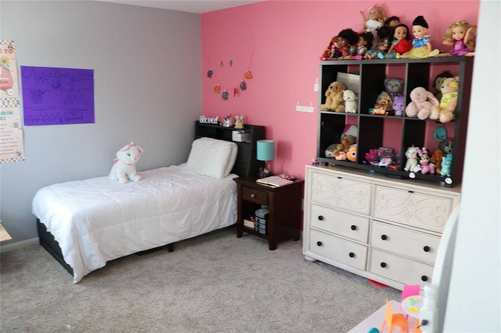 The third bedroom is spacious and well-lit, painted in a cheerful shade of pink. This creates a bright and inviting atmosphere, perfect for a child’s room. The color scheme adds a joyful and cozy feel to the space, making it a delightful and comfortable area for your daughter.