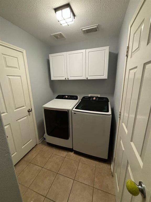 The laundry area is a functional and well-designed space, ample enough to accommodate both a washer and dryer. It provides convenient access to the garage, allowing for easy movement between the two areas.
