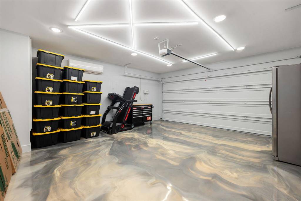 This garage is a dream for owners! The epoxy floor elevates this double wide garage and makes even this room in the home feel modern and special.