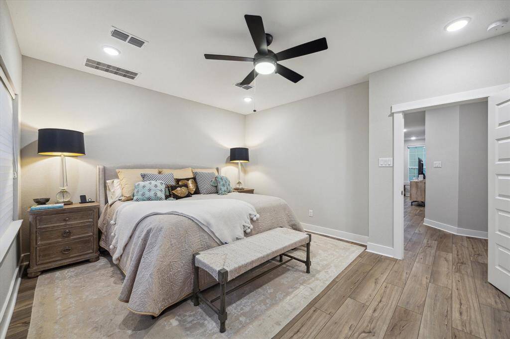 Here’s another angle of the stunning primary bedroom, highlighting its spacious layout, abundant natural light, and serene ambiance.
