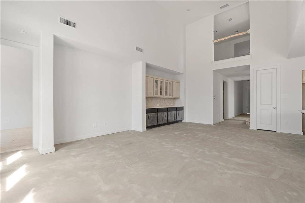 Soaring 18.5-foot ceilings create an airy, grand atmosphere.