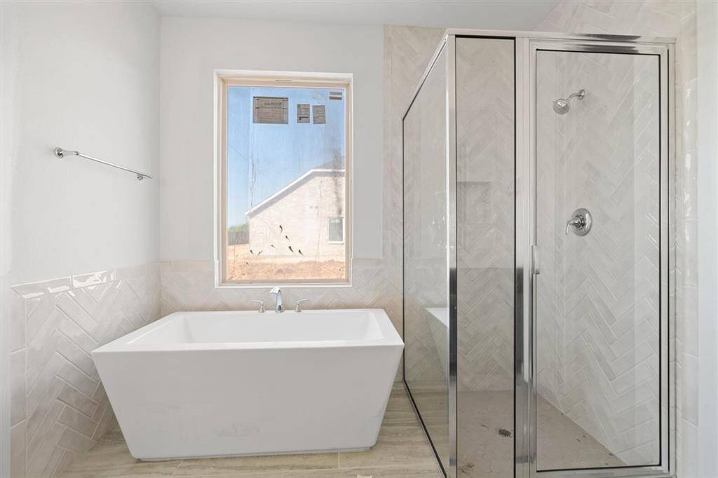 Take a break in your freestanding tub and read a book.