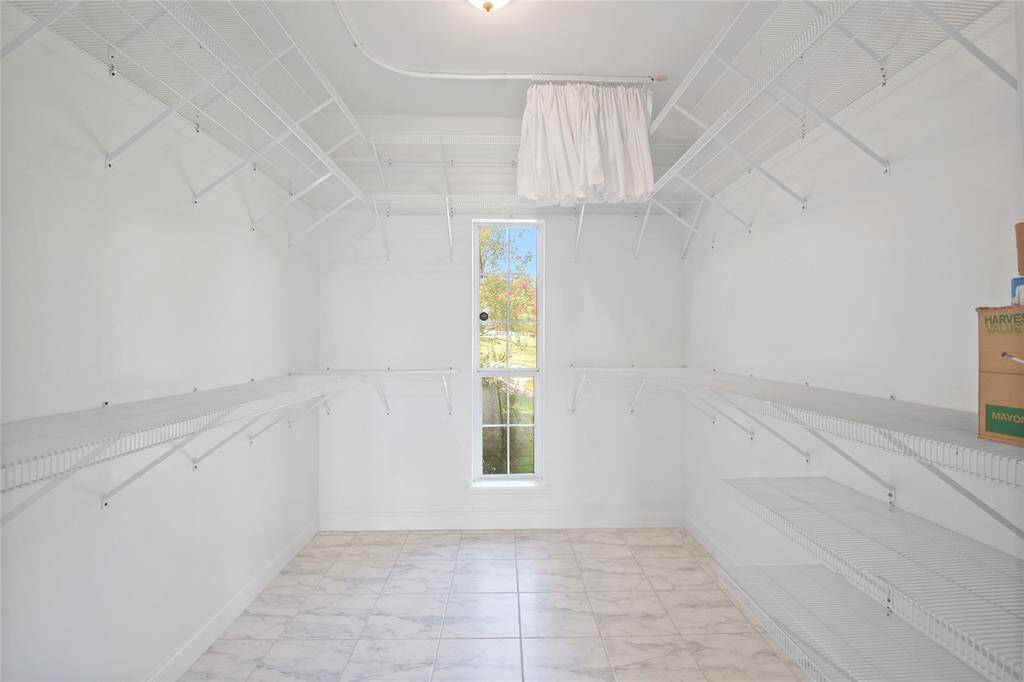 The Primary Suite closet is exceptionally large with tile flooring.  Excellent storage for either a weekend getaway home or a permanent home on the lake!