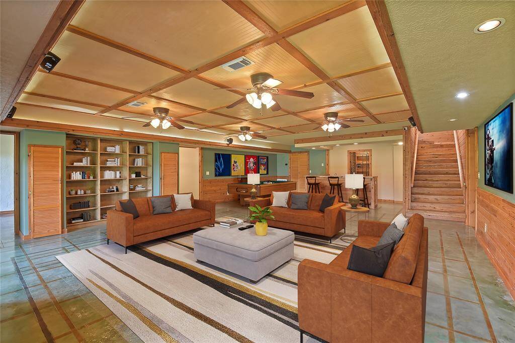 Taking the stairway down from the main level, this lower level features a large recreation area which may include seating area to watch movies or television; have space for a pool table or other large gaming table; and still have a fully functional bar area to serve everyone!  On each side of this large recreational space are guest bedrooms and bathrooms.