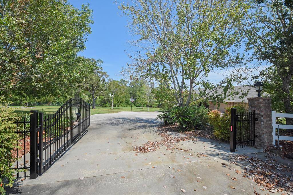 Welcome! The acreage is fenced and gated with controlled access. Drive into a large motor court area which can handle parking for large gatherings, parties, or occasions.