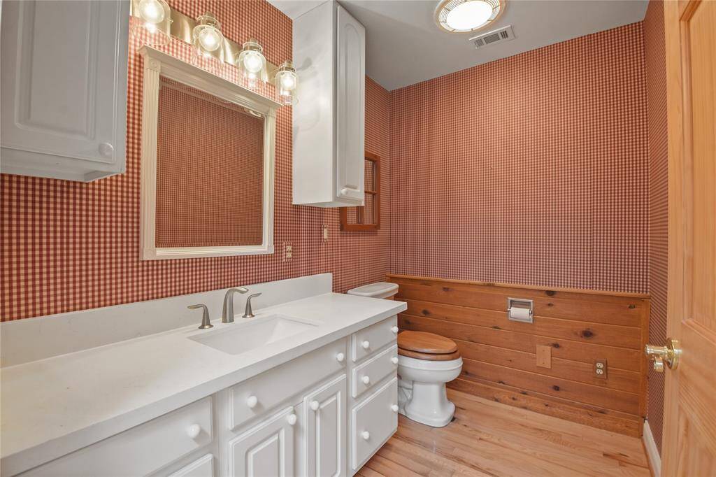 The guest half bathroom is immediately off of the main living area and entry.