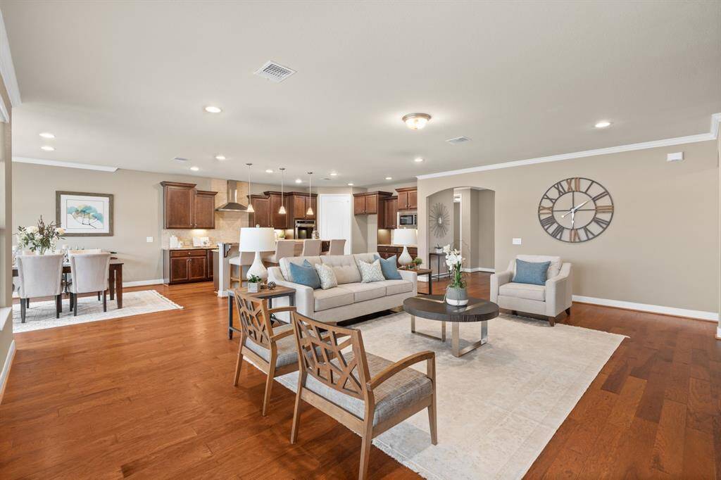 As you enter you are greeted by a spacious gathering room. The crown molding & 5 1/4" baseboards creates an added sense of depth & architectural interest. Floor outlet is perfectly positioned for your lamps.