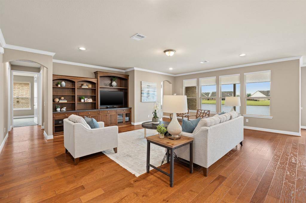 The built-in wood entertainment center is a true masterpiece, effortlessly commanding attention. Its stunning design naturally draws the eye, creating a stylish and functional focal point in the living space.