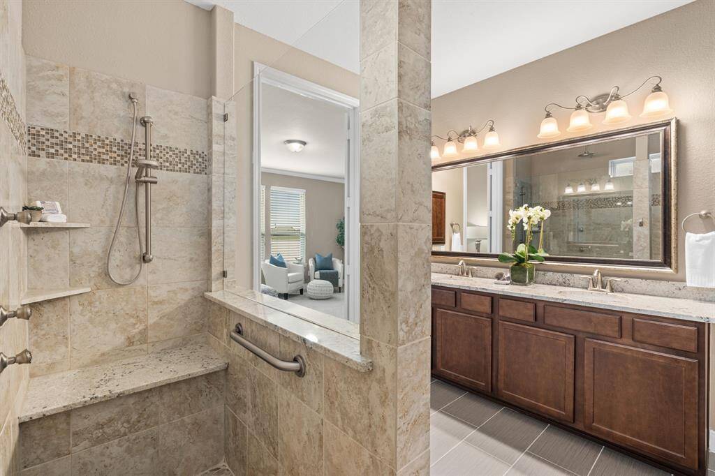 As you step into the shower, you'll appreciate the flush entry, bench and pebble stone flooring, an exquisite touch that elevates the experience. It's a space where you can truly unwind and rejuvenate, as the stresses of the day melt away.