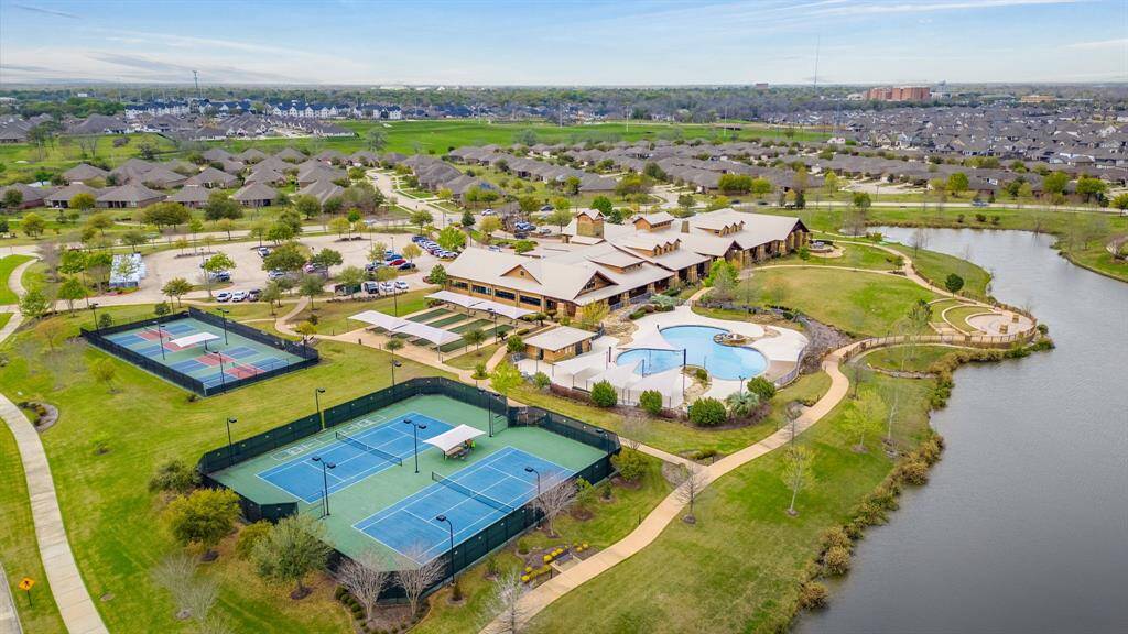 Discover the heart of the community at the Lakehouse, a sprawling 27,000 sq. feet amenity building designed to enhance your lifestyle with a wealth of recreational and social opportunities.4 Pickel ball courts & 2 Tennis courts. Putting green being installed in-between courts.
