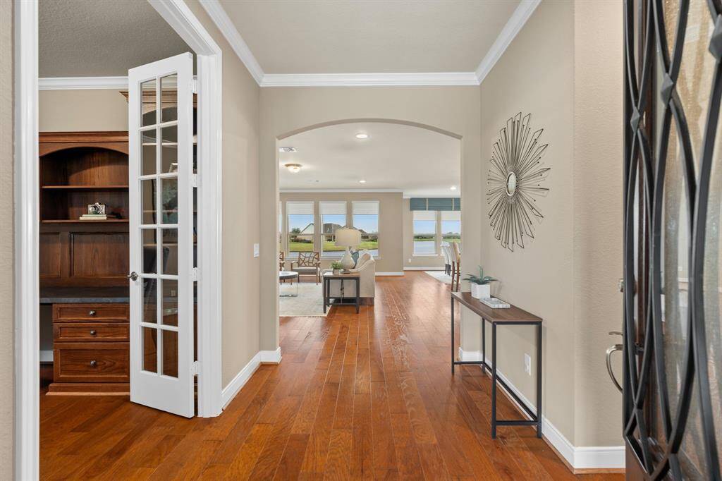 Step into luxury as you enter this stunning home! The beautiful wood flooring set the tone for elegance and charm throughout. A perfect blend of style and sophistication awaits you at every turn. Welcome home!