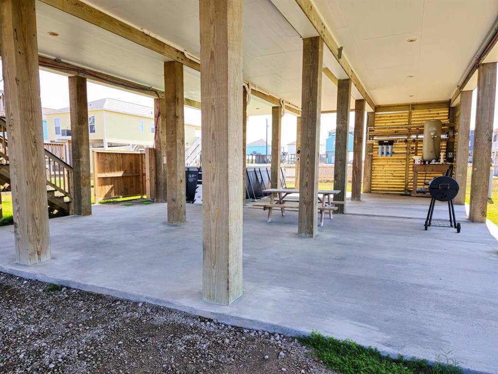 This photo shows the covered outdoor living space with a concrete slab, making it ideal for gatherings and outdoor activities.