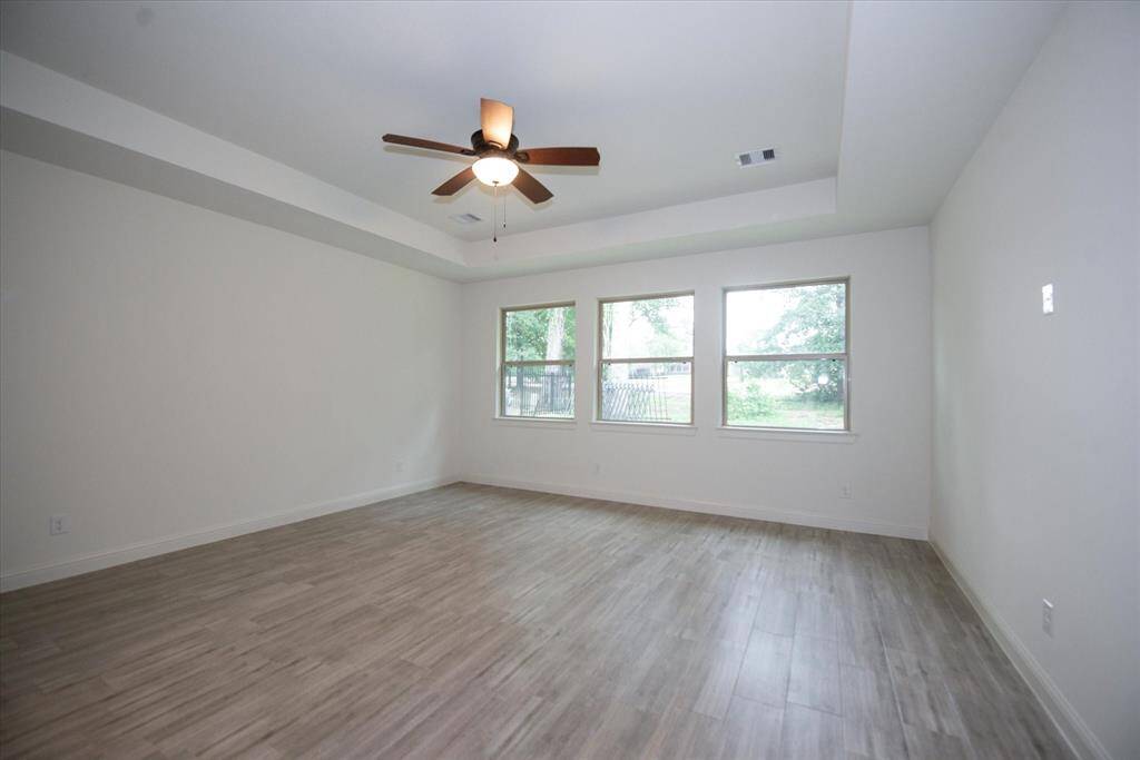 Primary bedroom has large double pane windows that allow so much natural light yet privacy since there are no neighbors on the other side.