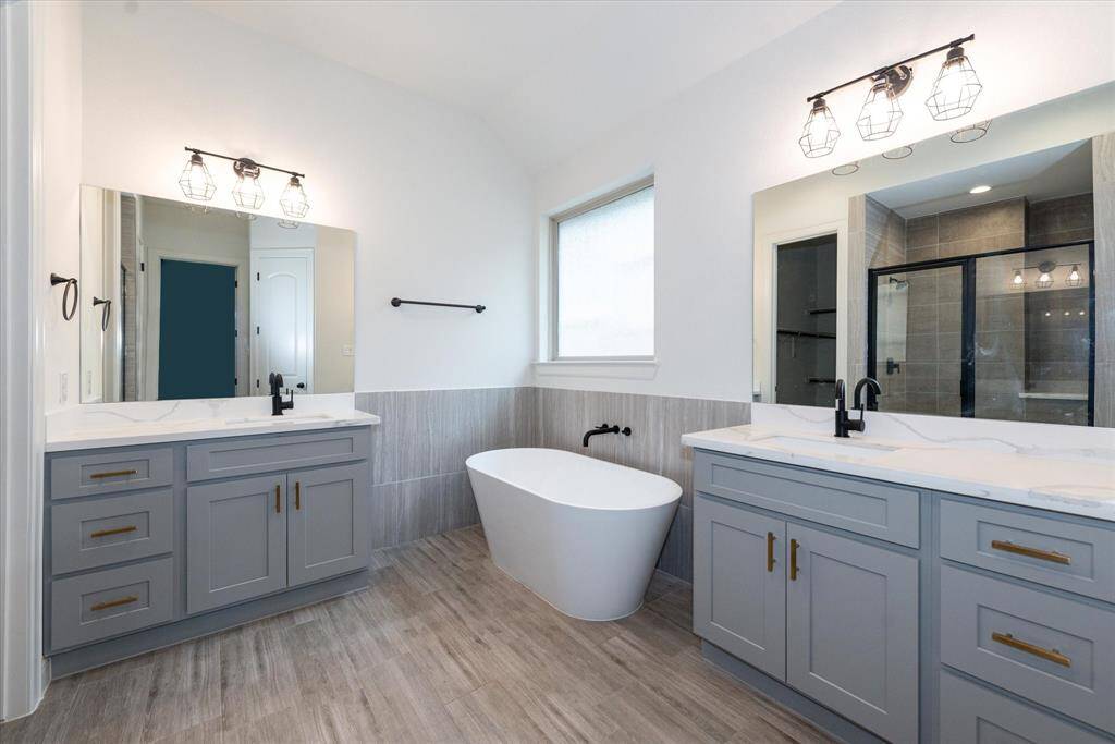 Primary Bathroom features two separate sinks and a beautiful tub