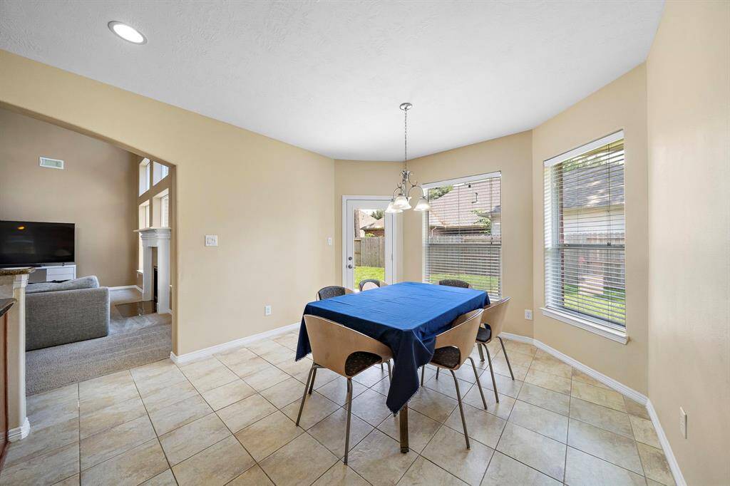 Enjoy your mornings in a bright breakfast area with a lovely view of the spacious backyard and abundant natural light.