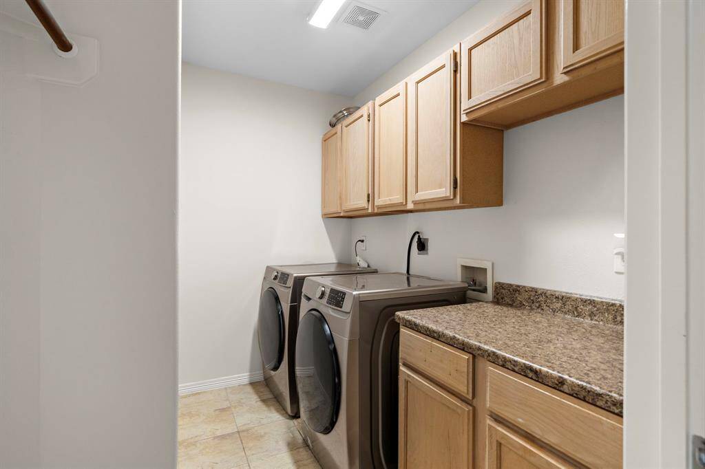Streamline chores with a convenient first-floor laundry room that offers easy access and practical functionality.