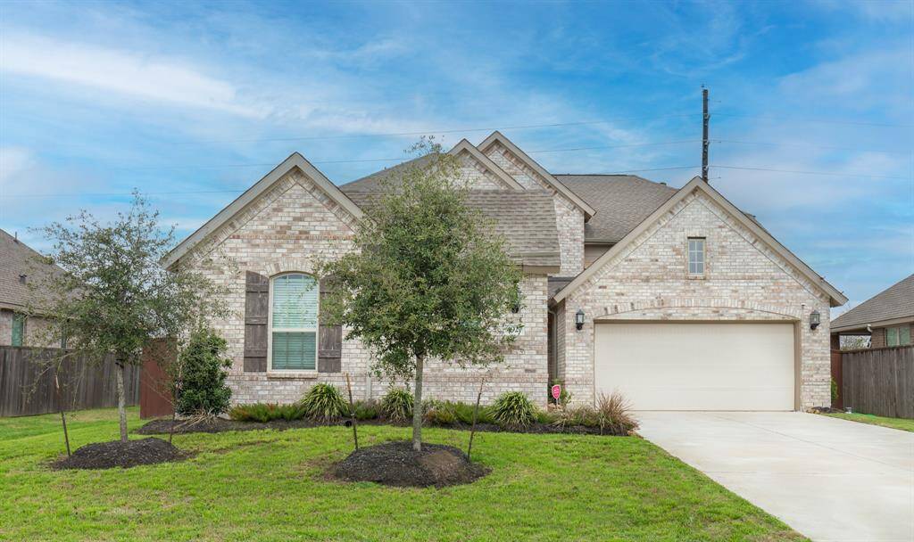 This charming home features a classic brick exterior and a two-car garage. The well-maintained front yard includes mature trees and neat landscaping, offering excellent curb appeal.