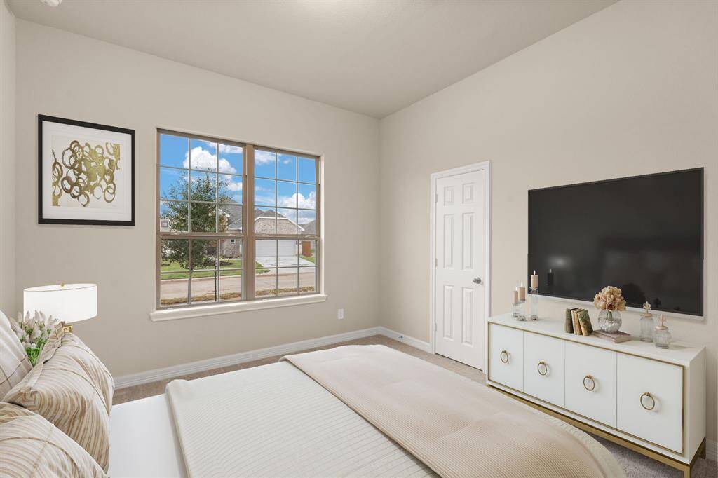 Your secondary bedroom features plush carpet, fresh paint, closet, and a large window that lets in plenty of natural lighting. Photo is virtually staged