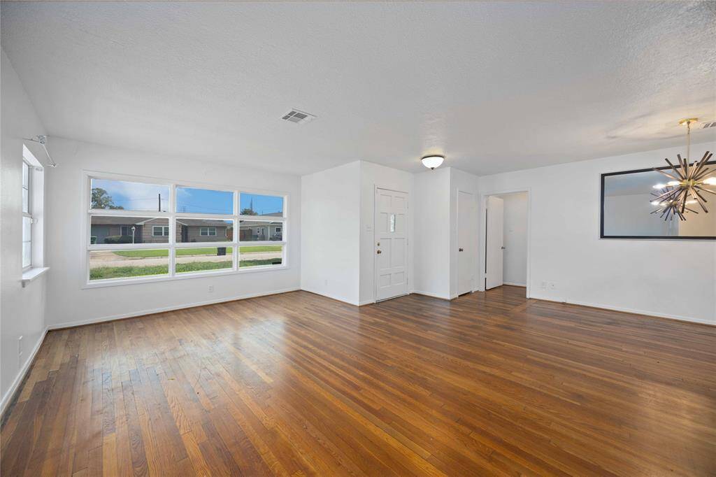 Large and open family and dining room with natural light shining in from the front window