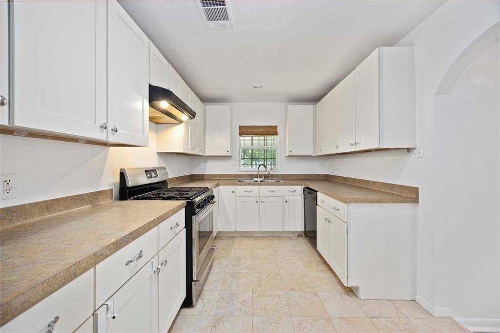 Sink under a windows overlooking the backyard
