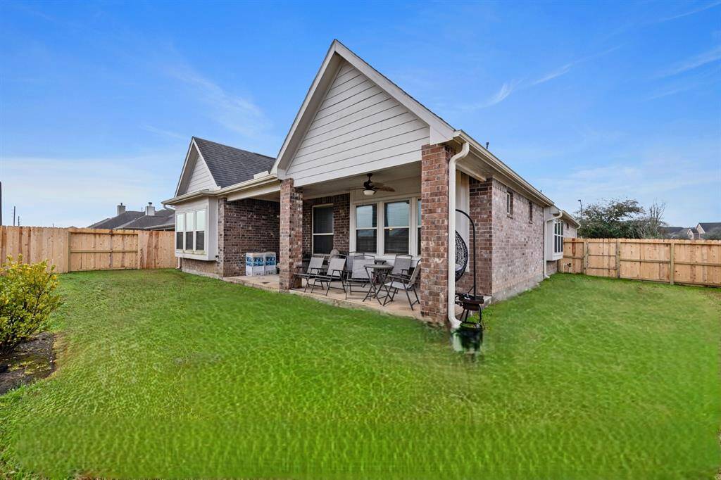 This corner lot without back neighbors has a new wood fence, and large covered patio with two ceiling fans.