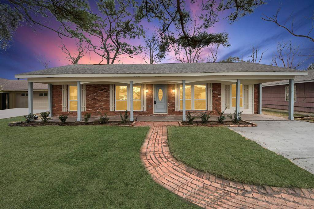 Charming single-story brick home with a welcoming front porch and well-maintained lawn. Features a curved brick pathway and a cozy, inviting exterior illuminated by warm lighting. Ideal for comfortable living in a serene neighborhood.