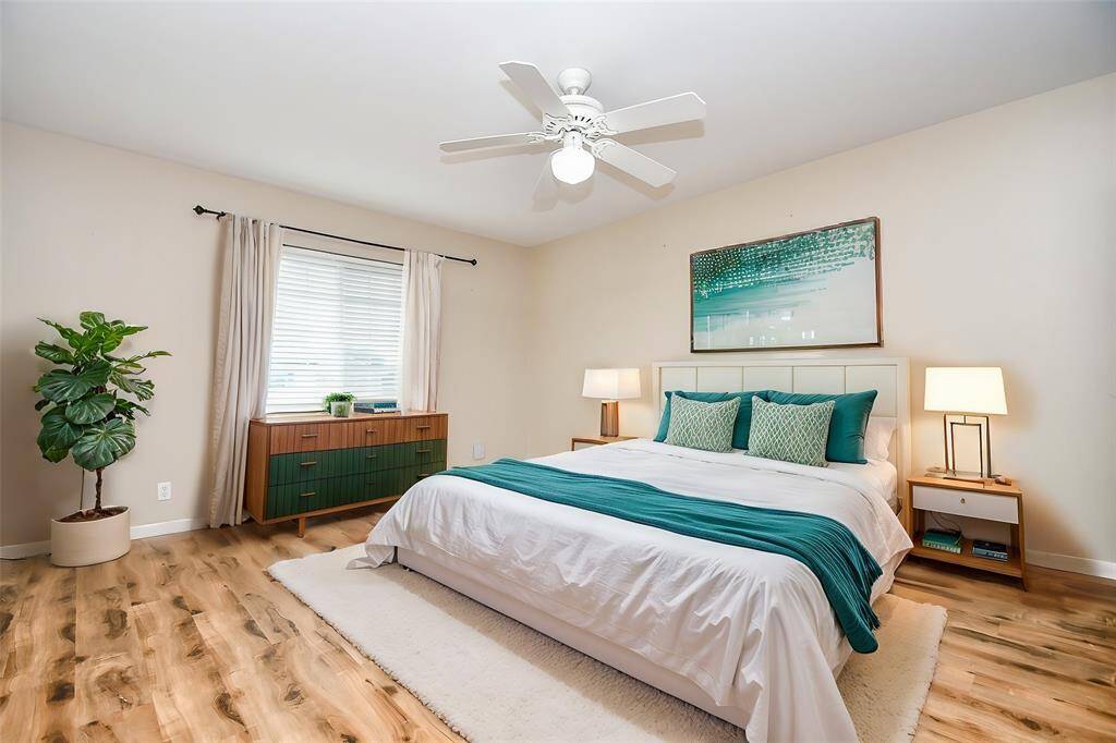 Spacious, light-filled bedroom with modern decor and stylish accents. Virtually staged to showcase its full potential.