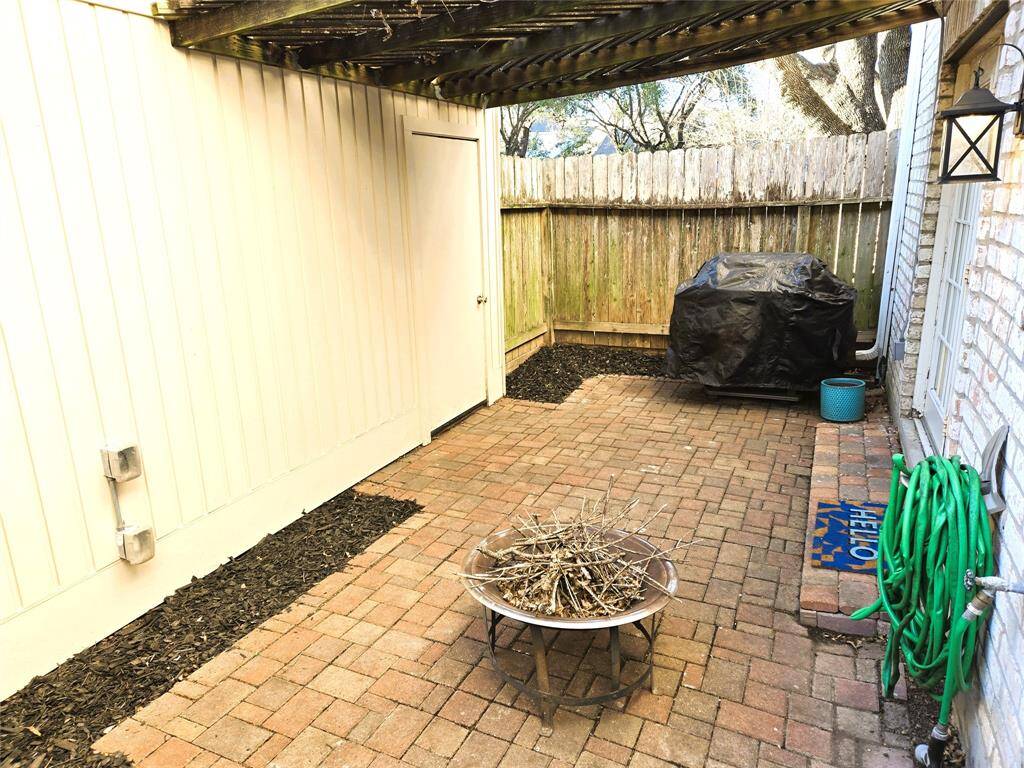 Back porch of pavestones has room for a fire pit and a BBQ pit