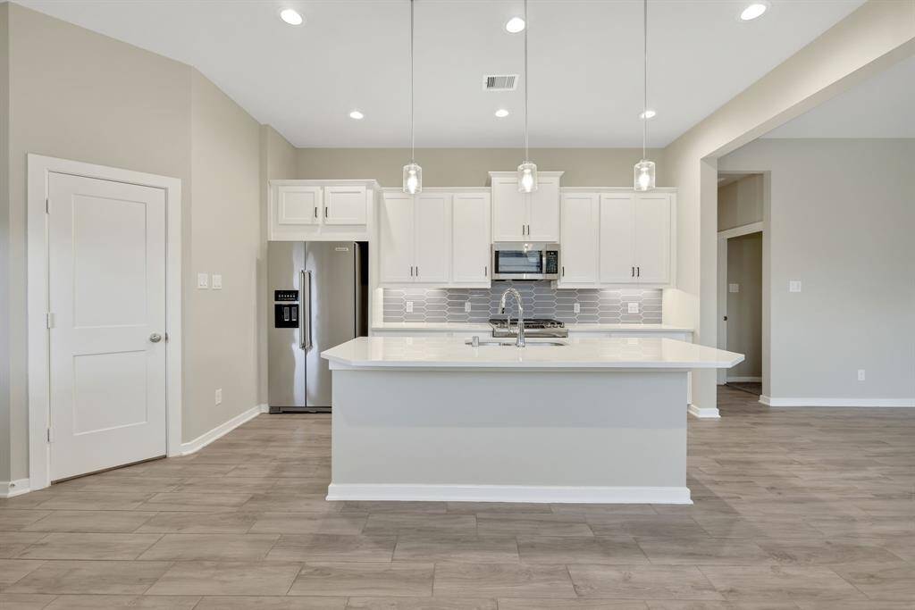 Walk in pantry and three pendants above the island/ breakfast bar plus lots of recess lighting