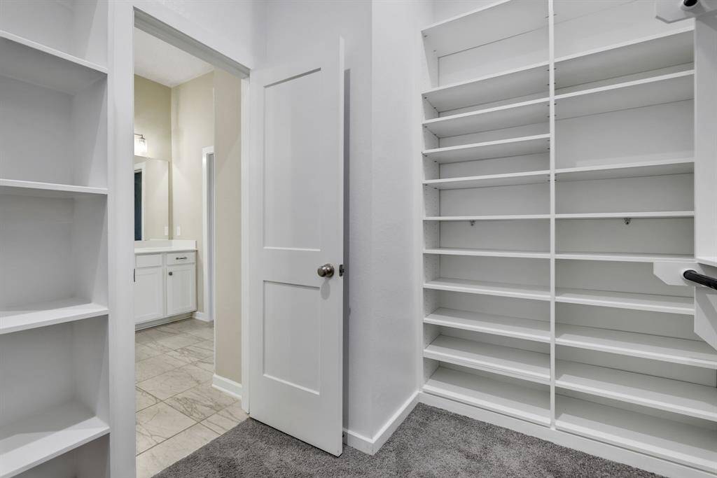 Primary closet is perfect. Check out all the shelves!