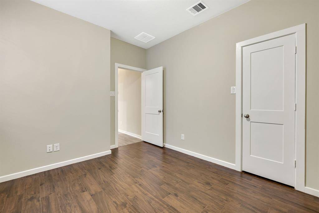 Secondary bedroom down also features no carpet and a walk in closet