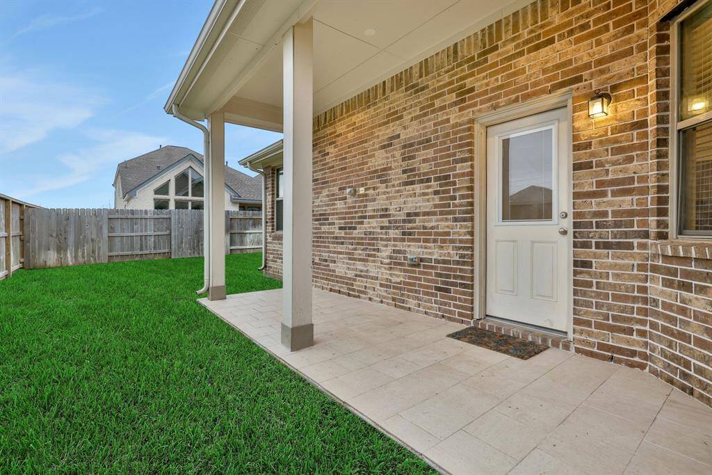 Outside is a covered and tiled patio