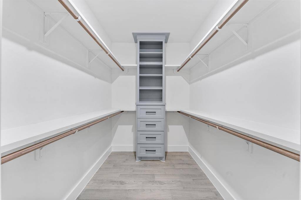 Primary bedrooms has a custom walk-in closet with built-in cabinetry.