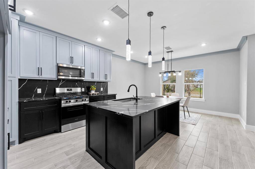 Stunning open-concept layout, where the kitchen seamlessly connects to the dining and living areas.