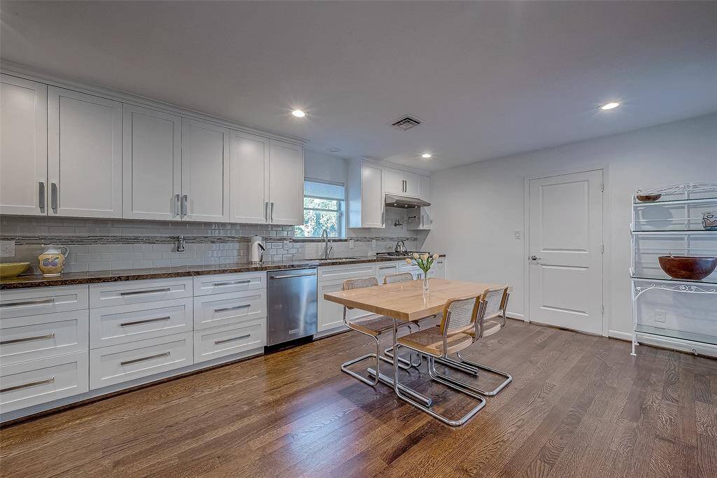 The door leads to the utility room and then outside to the deck and electric lift. Look at the amount of large drawers (so much better than cabinets!) and the upper cabinets go to the ceiling for extra storage.