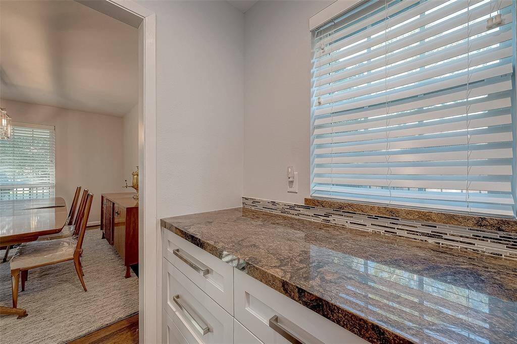 The butlers pantry has a window for natural light, more drawers and granite counter.