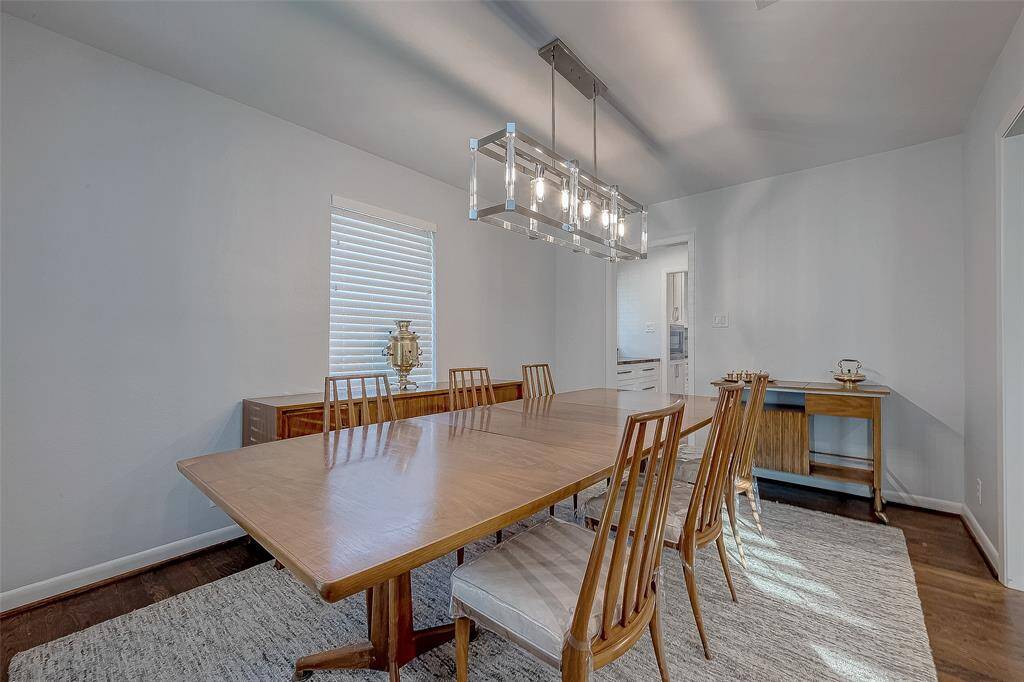 The formal dining room has wood shelves and a pretty chandelier.