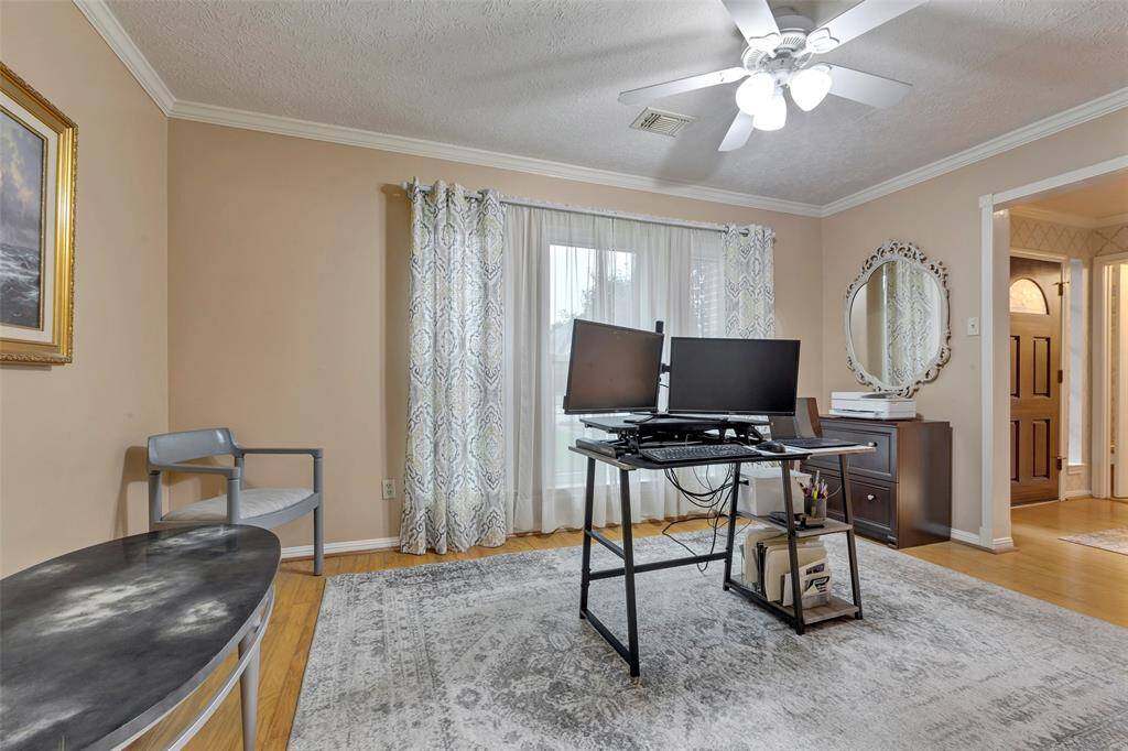 Currently functioning as a home office, this spacious dining room can comfortably fit a table for six and host your next dinner party.