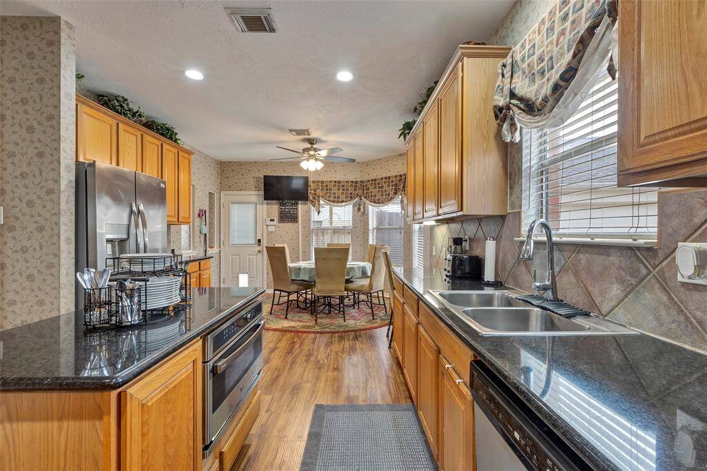 Another view of the kitchen. TV not to convey with sale of home. Custom window coverings.