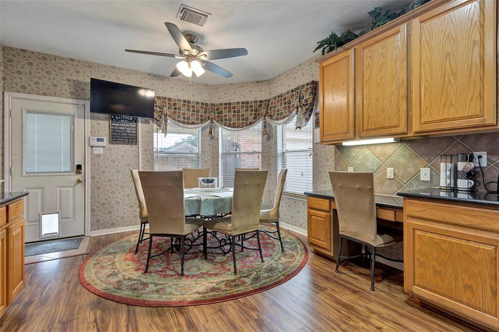 View of the breakfast room overlooking the the back yard and the back door.