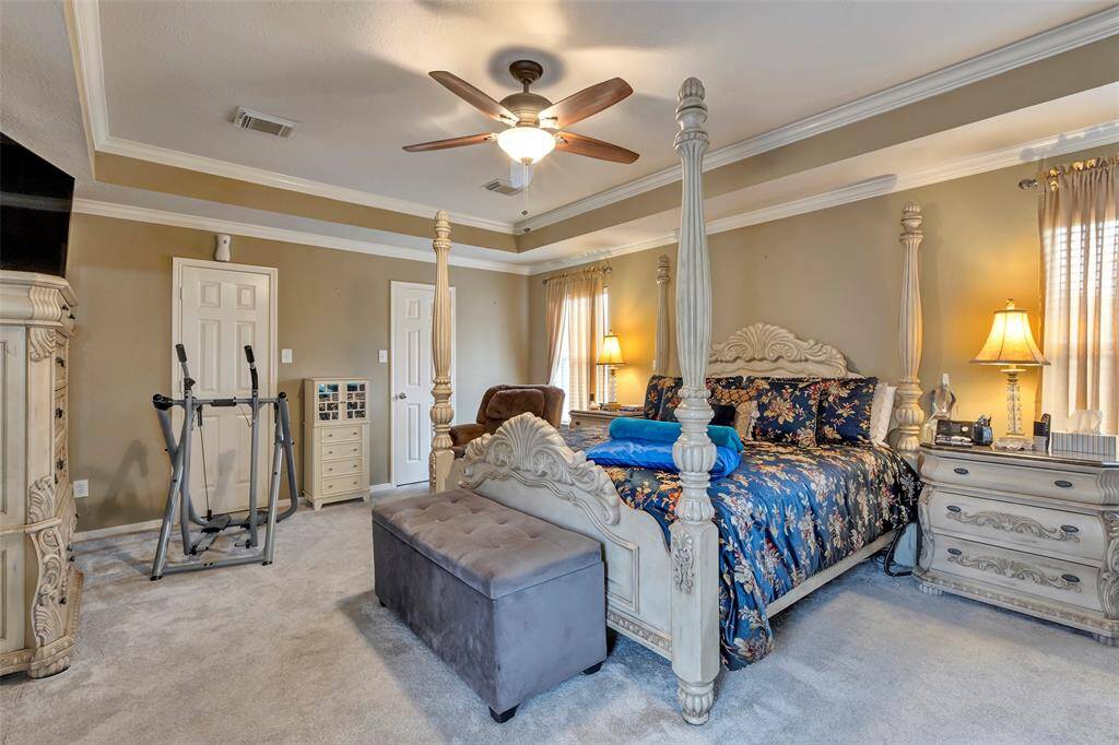 Spacious primary with large walkin closet. Ceiling fan with light, Crown molding and decorative ceiling