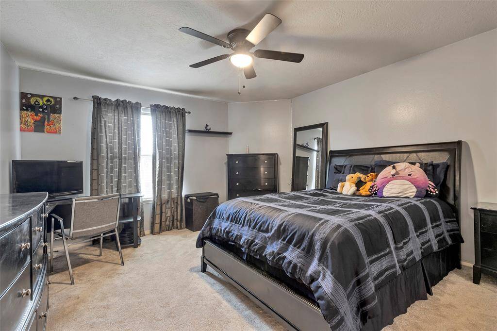 Third bedroom up in the back part of this home with ceiling fan and lights. Custom window coverings. There are 4 bedrooms upstairs.