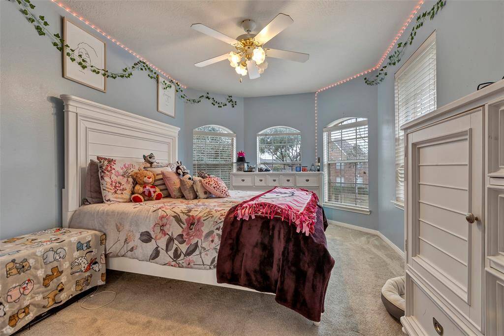 Upsatirs first Bedroom to left of stairs. This room is in the front of the home. Great room with lots of angles. Ceiling fan with lights and custom window covering.