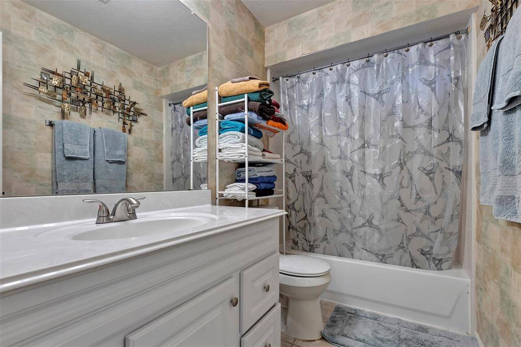 Second bath room upstairs shared with 2 bedrooms. Single sink. Tub/shower.Tile flooring.