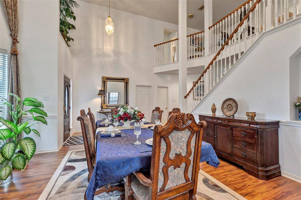 Grand stairs to game room up and 4 bedrooms 2 full baths. Art niche in formal dining room, living area.