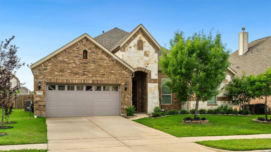 This stunning single-story residence boasts charming curb appeal with its elegant brick and stone exterior.