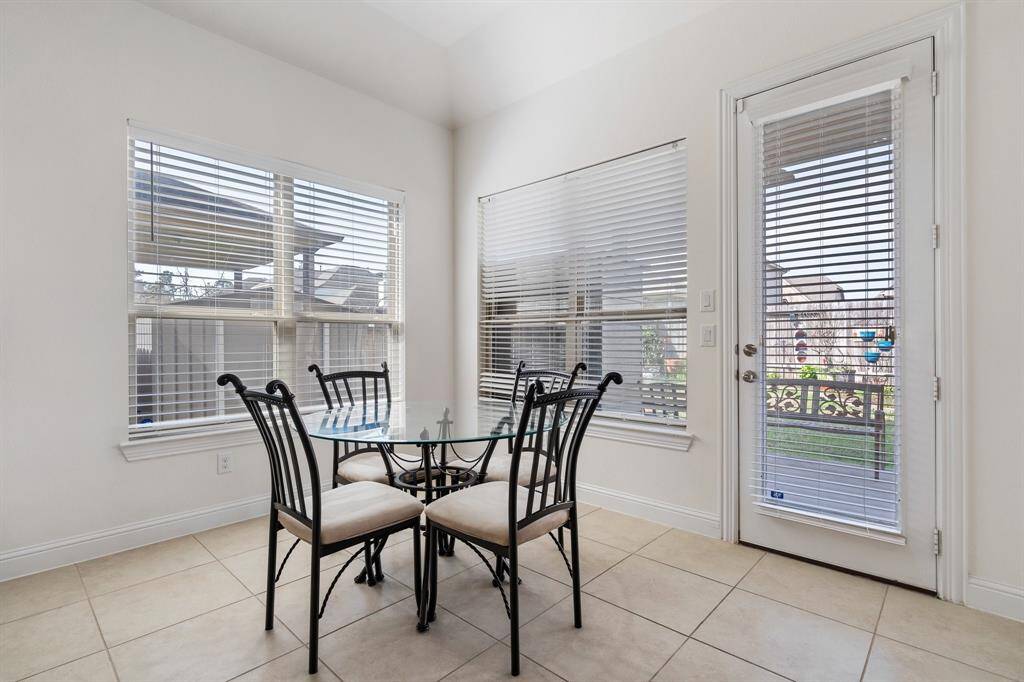 High-quality stainless steel appliances, including a built-in microwave and oven combination, as well as a gas cooktop with a sleek range hood.
