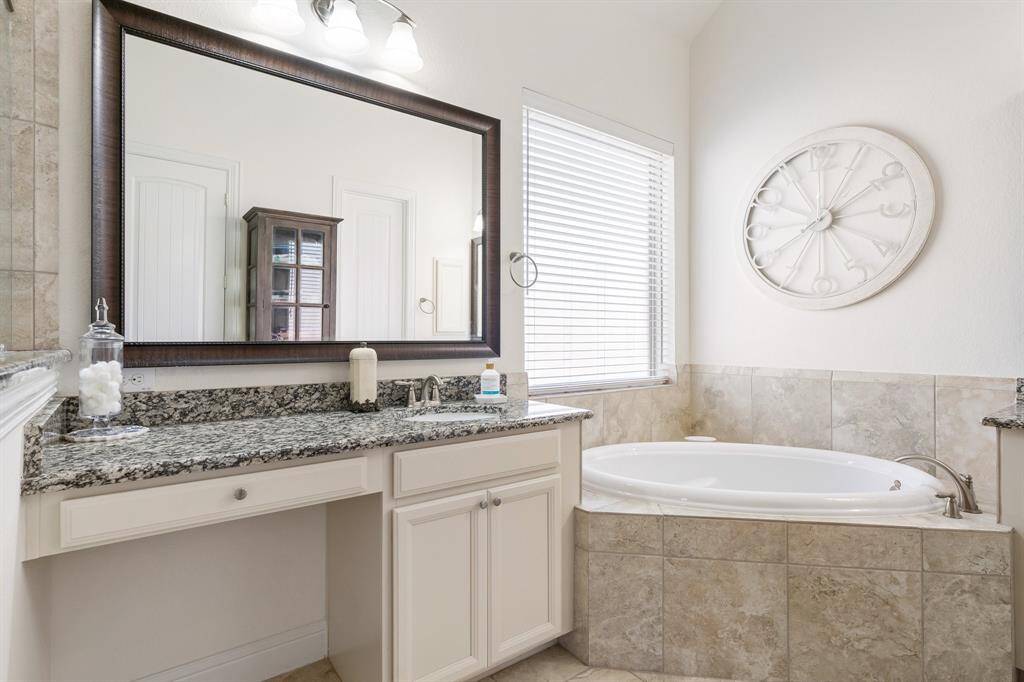 Spacious walk-in shower with elegant tile-work and a built-in shelf for convenience.